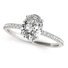 an oval cut diamond ring with pave set shoulders