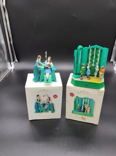 two figurines are sitting on top of each other