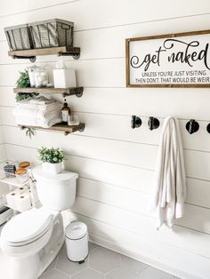 the bathroom is clean and ready to be used as a place for towels, toilet paper, and other things