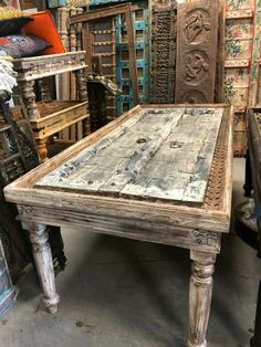 an old wooden table in a room filled with furniture