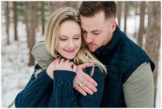 a man and woman embracing each other in the snow