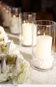 white flowers and candles are on the table