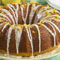 a bundt cake with icing and orange zest sprinkles on top