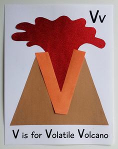 a piece of paper that has been cut out to make a volcano with the letter v on it