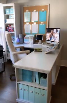 a desk with a computer monitor, keyboard and drawers on it in an office setting