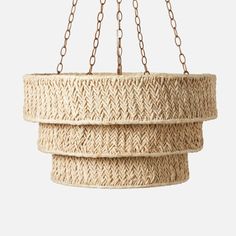 three hanging baskets with chains attached to the bottom and one is made out of jute