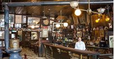 a man standing behind a bar in a restaurant