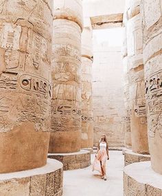 a woman walking through an ancient egyptian temple