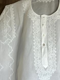 Hand embroidered classic round neck cotton kurta for men. "Size mentioned is the actual garment measurement" Festive Traditional Tops With Tonal Embroidery, Traditional Fit White Top, Folk Style Cotton Kurta For Traditional Ceremonies, Traditional Tops With Tonal Embroidery For Festive Occasions, Traditional White Tops With Chikankari Embroidery, Traditional White Tops, Traditional White Top, Cotton Kurta With Floral Embroidery For Traditional Ceremonies, Traditional Long Sleeve Kurta With Cutwork