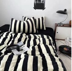 a black and white striped bed with two pillows