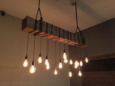 the light bulbs are hanging from the wooden beam