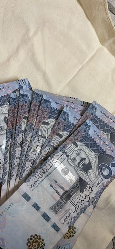 five folded bills sitting on top of each other