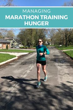 a woman running down the road with text overlay reading managing marathon training hunger