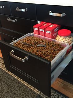 a drawer with some food in it and two boxes on the floor next to it