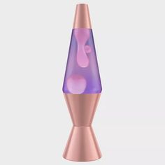 a pink and purple vase sitting on top of a table