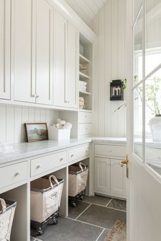 a white kitchen with lots of cabinets and drawers