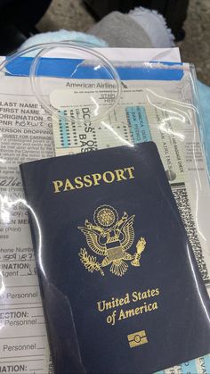 an american passport sitting on top of a pile of paper and plastic wrap around it