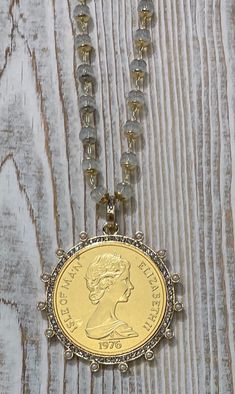 This stunning Queen Elizabeth II Coin Pendant is a show stopper. It comes on a 20" clear crystal chain but if you want it on one of my gold chains just email me. It's made of Cast Zinc Alloy, and the gold coins are brass and gold plated. Please allow a 1-3 handling time for in-stock items and 4-6 handling time for out of stock items.  Measure - Bezel = 50mm                 Coin =  38mm                 Bale = ID 7.28mm                 Bale = OD11.43mm Queen Elizabeth Ii Coin, Citrine Crystal Necklace, Kyber Crystal, French Coins, Reine Elizabeth Ii, Reine Elizabeth, Jewelry Quotes, Citrine Crystal, Crystal Chain