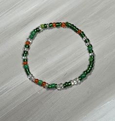 Green bead bracelet, perfect for older children and teens. stretch bracelet comes in two color combos; shiny beads or matte beads. This color variation is great for St Patricks Day. bracelet is available in several sizes. comes ready to gift with organza bag and gift card.   Mix and match multiple colors to wear together! Casual Stretch Bracelet With Tiny Beads, Trendy Green Bracelets With Tiny Beads, Green Beaded Bracelets With Letter And Round Beads, Trendy Green Hand-strung Beaded Bracelets, Trendy Green Spacer Beads, Casual Elastic Beaded Bracelets As Gift, Casual Green Beaded Bracelets, Adjustable Green Stretch Bracelet As Gift, Casual Green Stretch Bracelet With Letter Beads