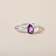 Crafted in 1.49 grams of 10K White Gold, the ring contains 22 stones of Round Natural Diamonds with a total of 0.155 carat in F-G color and I1-I2 clarity combined with 1 stone of Simulant Amethyst Gemstone with a total of 0.797 carat. Ring Size: US 7 Purple Ruby Ring With Diamond For Anniversary, Amethyst Diamond Ring For Promise, Amethyst Promise Ring With Diamond Accents, Amethyst Ring With Diamond Accents For Promise, Purple Diamond Ring With Birthstone, Purple Diamond Ring With Vvs Clarity, Real Gold Jewelry, Real Jewelry, Gold Diamond Jewelry