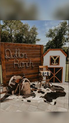 there is a sign that says butter ranch next to a chair and cow skin rug