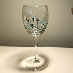 a wine glass sitting on top of a table