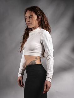 White cyberpunk crop top with long sleeves. Edgy and unique design inspired by Sci Fi.  KEY FEATURES - Special neckline - for an edgy look; - Made with special stretchy threads - Qualitative dense jersey fabric. - Labels are sewn on separately so you can remove them without damaging the garment. SIZE & MEASUREMENTS All sizes are given in the last picture. The fabric is stretchy. If you aren't sure about the size, add your bust, waist, hips, and height measurements as a note. FABRIC: White textur Punk Style Stretch Cropped Tops, Punk Style Cropped Stretch Tops, Stretch Cropped Punk Tops, Stretch Punk Crop Top For Streetwear, Punk Style Long Sleeve Stretch Crop Top, Punk Style Cropped Fitted Top, Fitted Cropped Punk Tops, Fitted Crop Top For Club In Winter, Fitted Winter Crop Top For Club