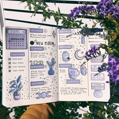 an open notebook with stickers on it sitting in front of purple flowers and greenery