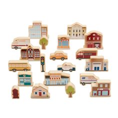 a bunch of wooden toys that are in the shape of small houses and cars on a white background