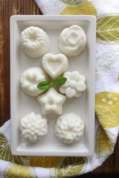 some food is on a white plate with green leafy garnishes in the middle