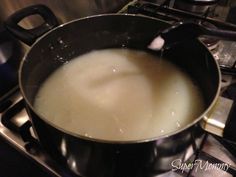 a pot filled with liquid sitting on top of a stove