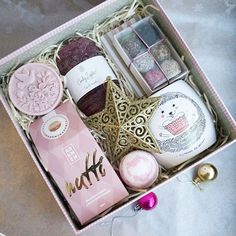 an open pink box with various items in it