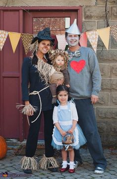 the family is dressed up in costumes for halloween