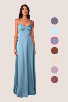 a woman in a long blue dress standing next to an assortment of color swatches