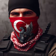 a man wearing a red bandana with a black eagle and turkish flag on it