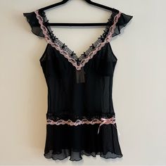 This Is The Coolest Little Tank Ever! Sheer Black With Pink Trim, And Lined With Lace Bunnies. It Even Has "Playboy" Embroidered In, And A Little Pink Bow On The Bottom. Ruffled Sleeves And Hem Just To Top It All Off. Brand New With Tags! All Measurements Are Approximate And Taken With The Item Laid Flat. Chest: 16" Hips: 17" Length: 25" Sleeve: 3" Waist: 14.5" Black Feminine Camisole For Party, Pink Sheer Camisole Top, Pink Fitted Camisole For Night, Coquette Pink Top For Party, Pink Camisole Top With Coquette Style, Pink Fitted Coquette Camisole, Pink Coquette Camisole Top, Black Coquette Camisole Top, Feminine Fitted Black Sleepwear