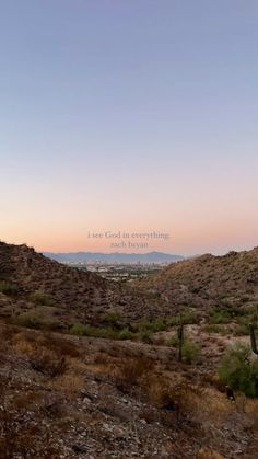 the sun is setting in the desert with mountains and cactus