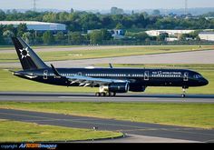 an airplane is on the runway with grass and trees in the backgrouds