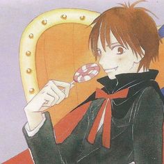 an anime character holding a lollipop in his hand