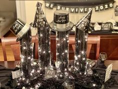 a table topped with black and silver decorations