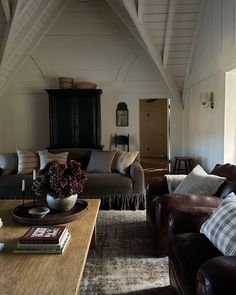 a living room filled with furniture and a wooden table