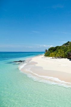 the beach is clear and blue with white sand