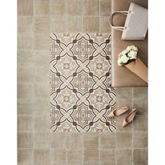 an overhead view of a tiled floor with shoes and flowers