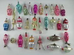 a collection of assorted glass bottles and spoons on a white surface, all in different shapes and sizes