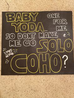 a baby yoda sign is on the floor next to a wall that says, baby yoda so don't make me go soloo?