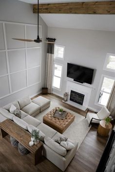 an overhead view of a living room with white furniture