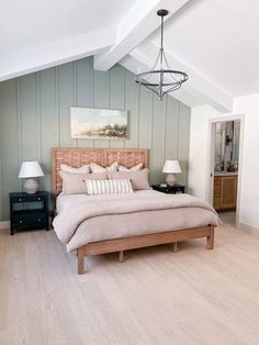 a large bed sitting inside of a bedroom on top of a hard wood floor