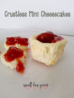 small miniature cheesecakes with strawberry jam on them are sitting on a white plate