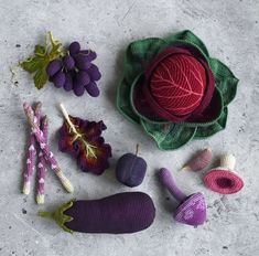 crocheted vegetables and fruits are laid out on the ground