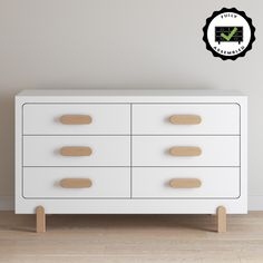 a white dresser with wooden handles and knobs